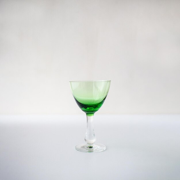 Close-up of wineglass on table against white background