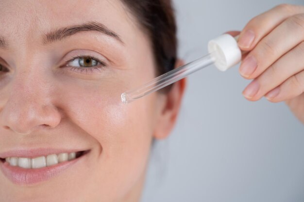 Close-up of woman applying medicine