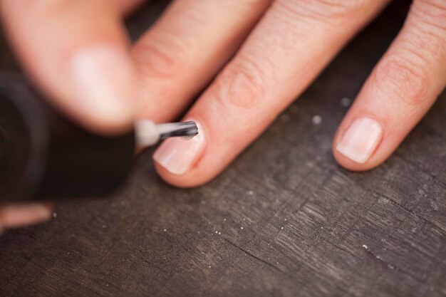 Photo close-up of woman applying nail polish