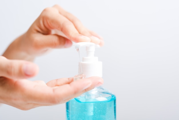 Close up woman applying sanitizer alcohol gel to hand