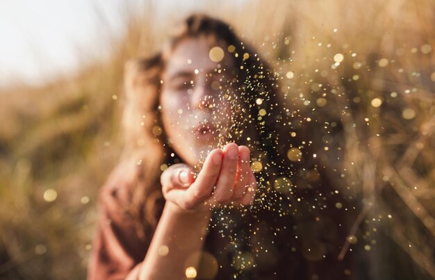 Photo close-up of woman blowing crops