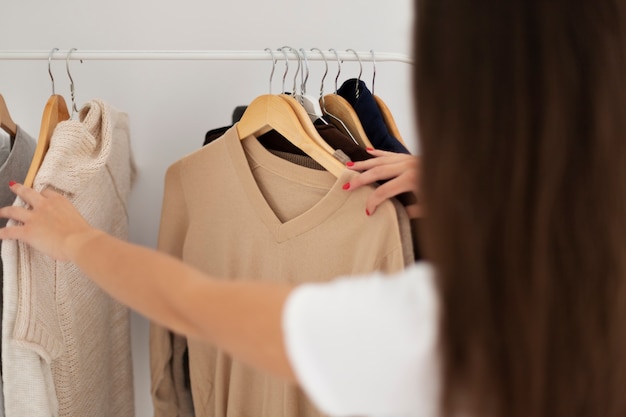 Close up woman cleaning wardrobe