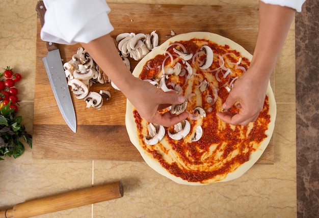 close up woman cooking pizza