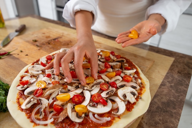 close up woman cooking pizza