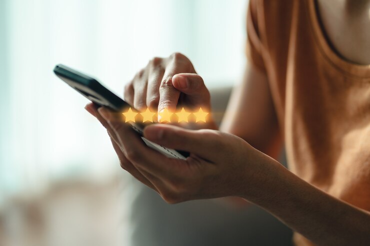Photo close up of woman customer giving a five star rating on smartphone. review, service rating, satisfaction, customer service experience and satisfaction survey concept.