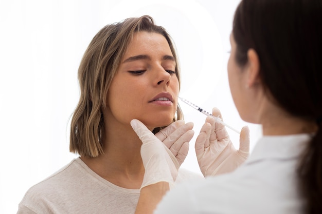 close up woman doing lip filler