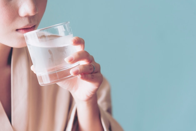 Close up on woman drinking fresh cold water