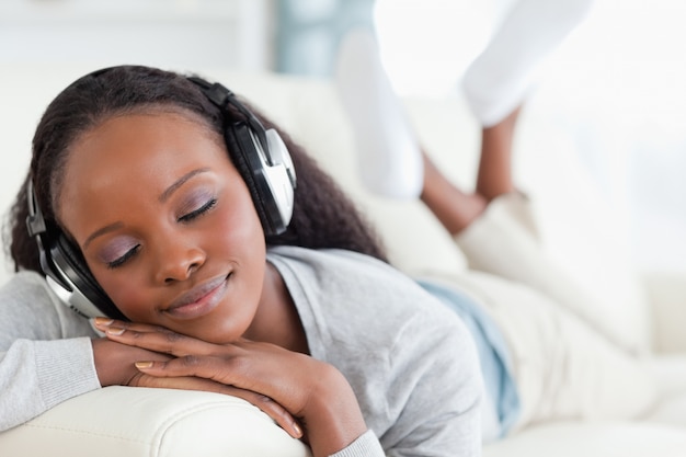 Close up of woman enjoying music on sofa