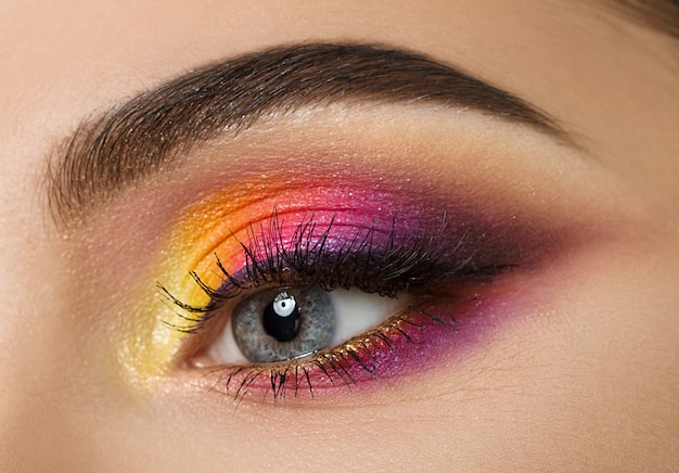 Close-up of woman eye with beautiful colourful makeup