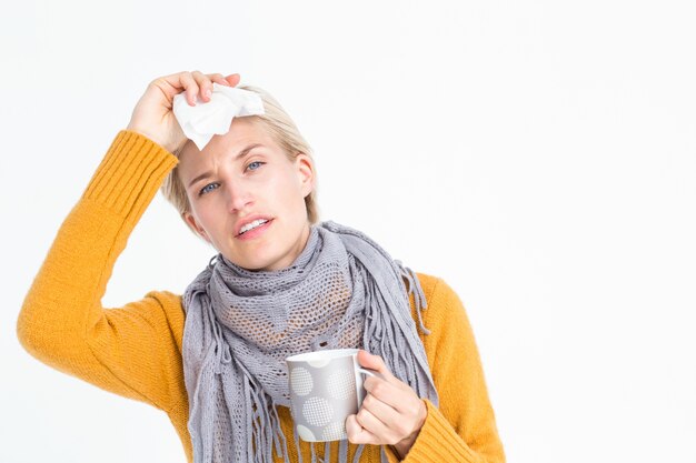 Close up of woman feeling her forehead