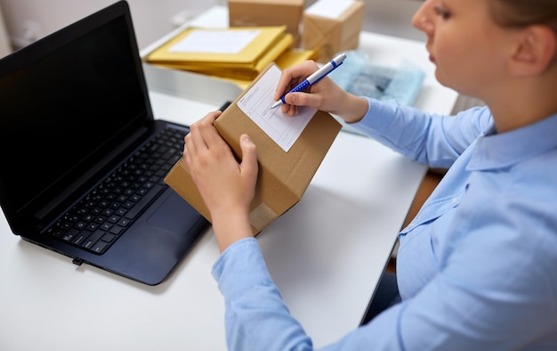 close up of woman filling postal form at office