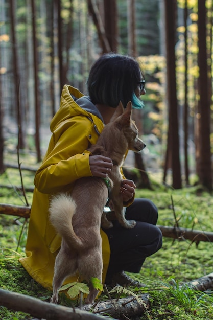 Close up woman on forest walk with small dog concept photo