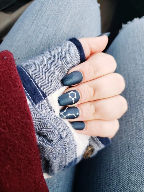 Close-up of woman hand on asphalt