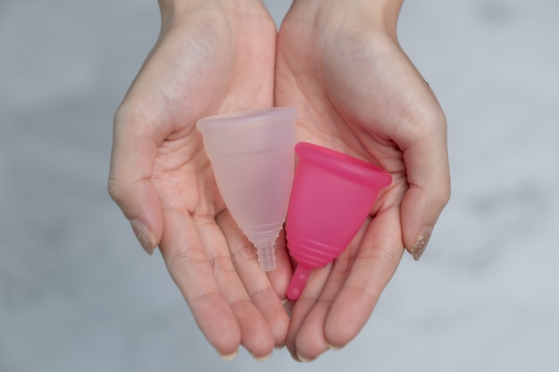 Close up of woman hand holding menstrual cup.