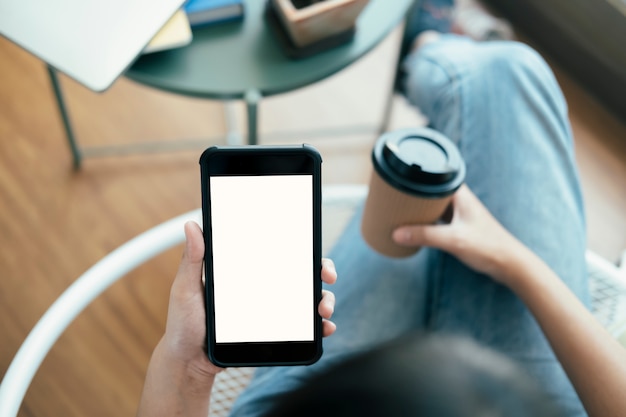 Close up of woman hand holding smart phone. Blank screen mockup for graphics display montage.