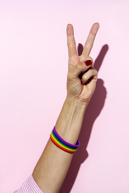 Foto close-up della mano di una donna su uno sfondo rosa