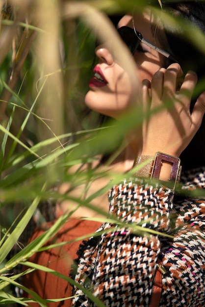 Photo close-up of woman hand on plant at land