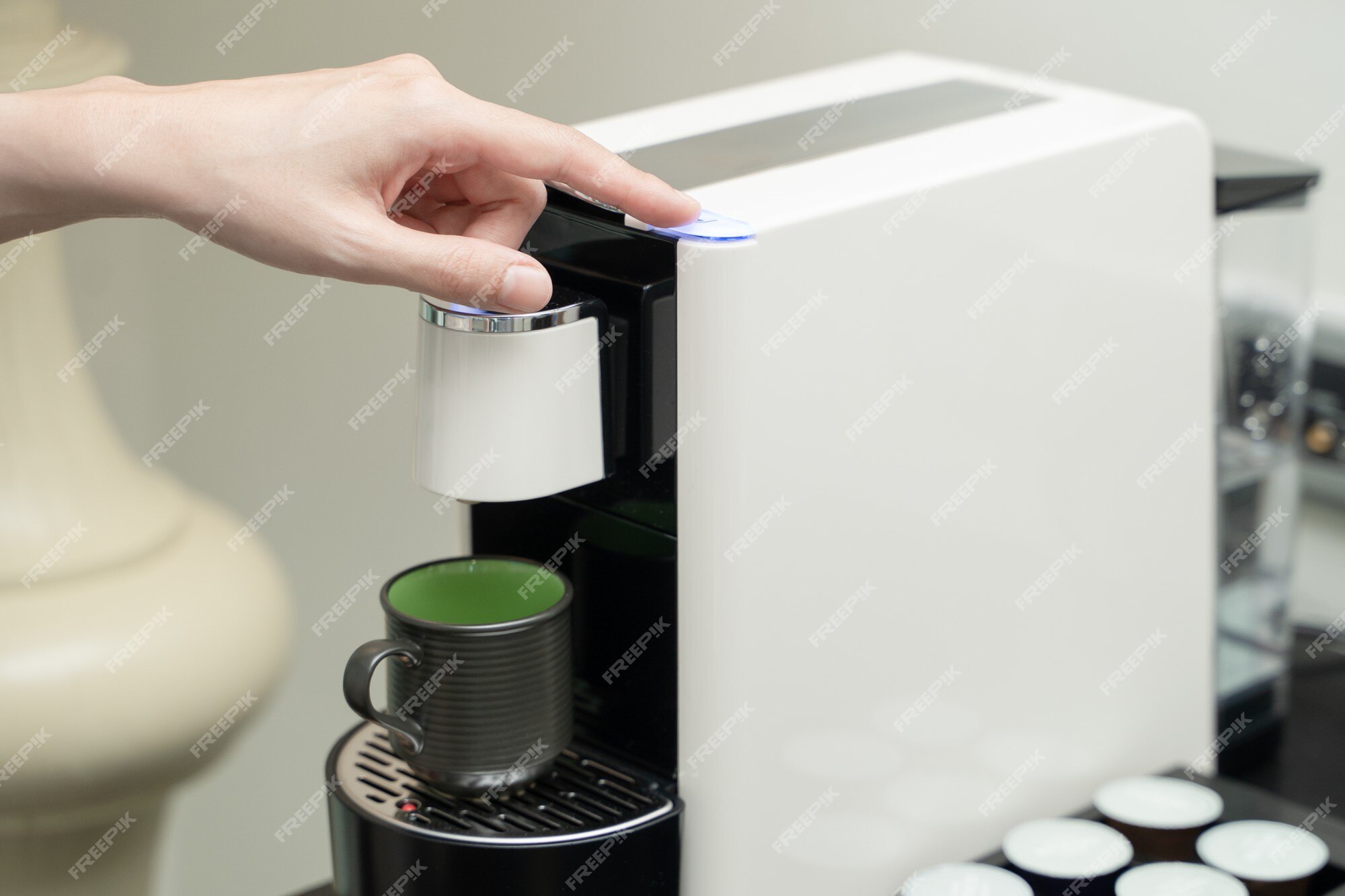 Premium Photo  Close up of hand inserting a capsule into a coffee machine  at home.