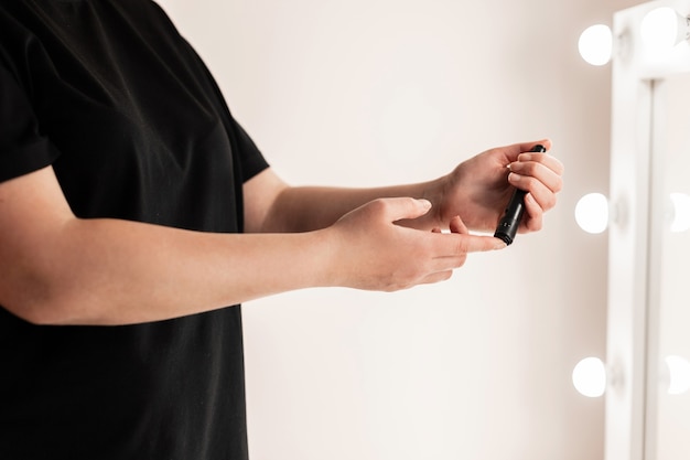 Close up of woman hands using lancet on finger to check blood sugar level by Glucose meter using as Medicine, diabetes, glycemia, health care and people concept.