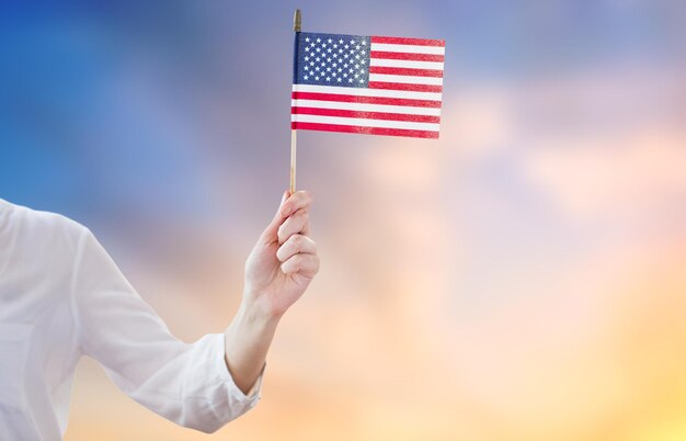 Close up of woman holding american flag in hand