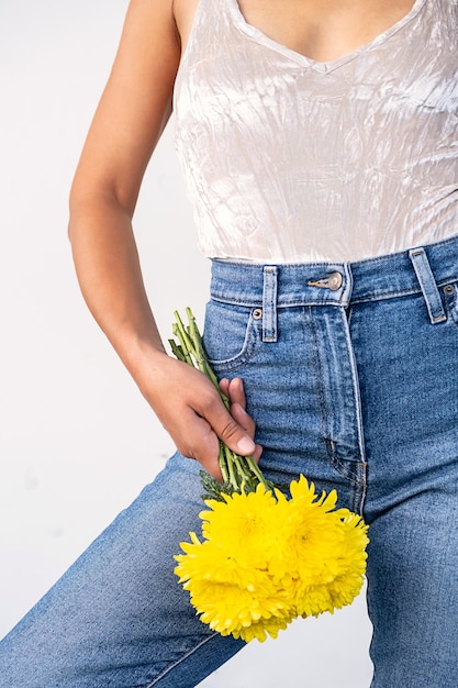 Close up of woman holding bouquet of yellow flowers