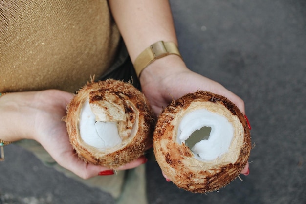 Photo close-up of woman holding coconuts