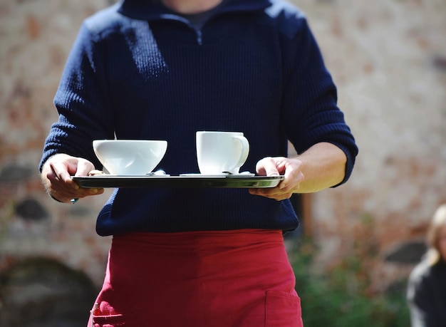 Photo close-up of woman holding coffee cup at cafe