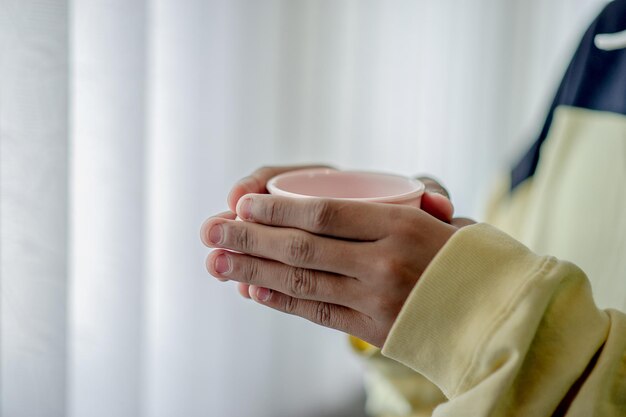 Close-up of woman holding coffee cup