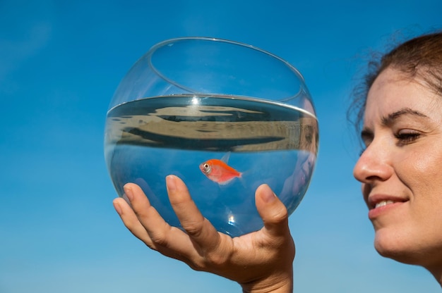 Photo close-up of woman holding crystal ball against sky