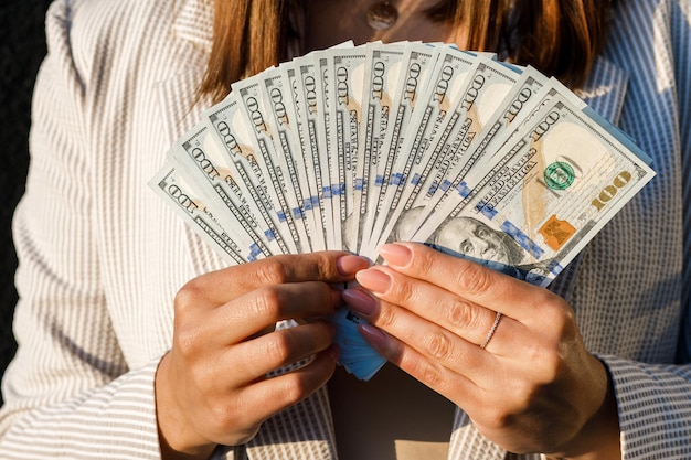 Close up of woman holding dollar bills Currency market development concept