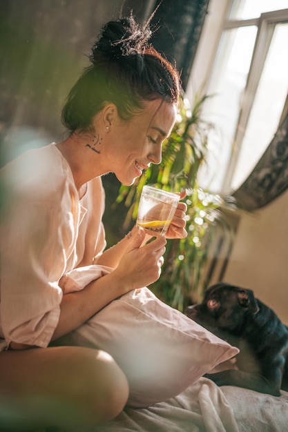 Photo close-up of woman holding drink sitting outdoors