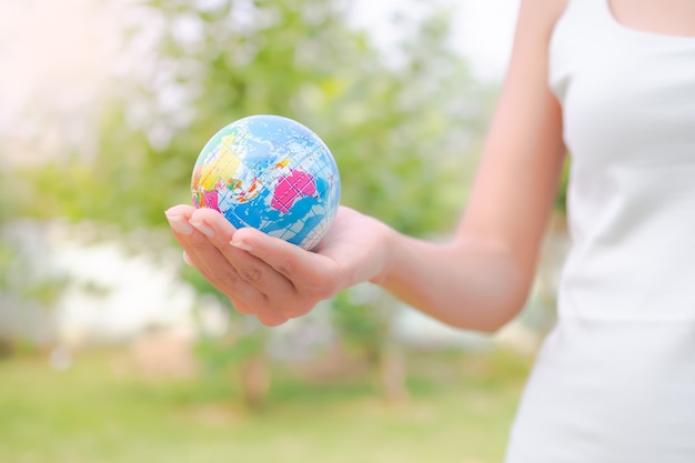 Close up woman holding earth. environmental conservation Earth Day concept.