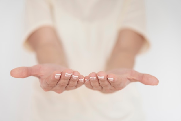 Close-up of woman holding hands out