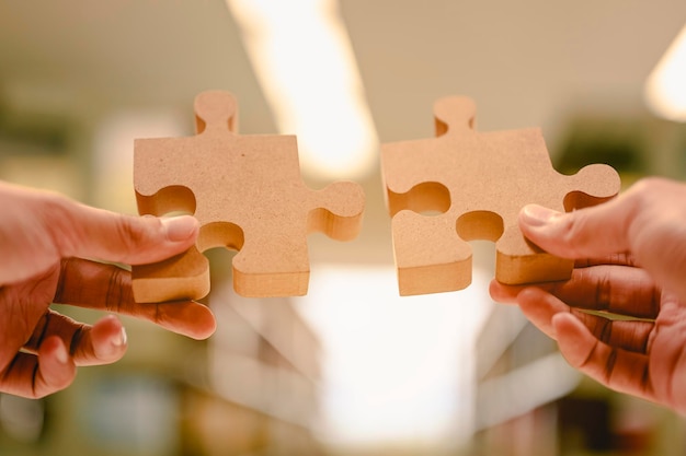 Close-up of woman holding jigsaw pieces