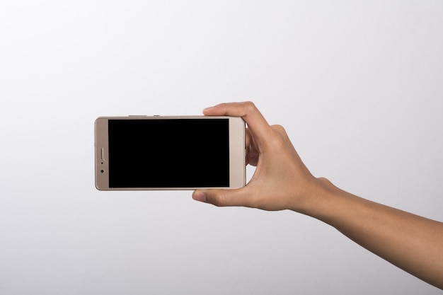 Close Up of a woman holding on mobile phone isolated on white background.