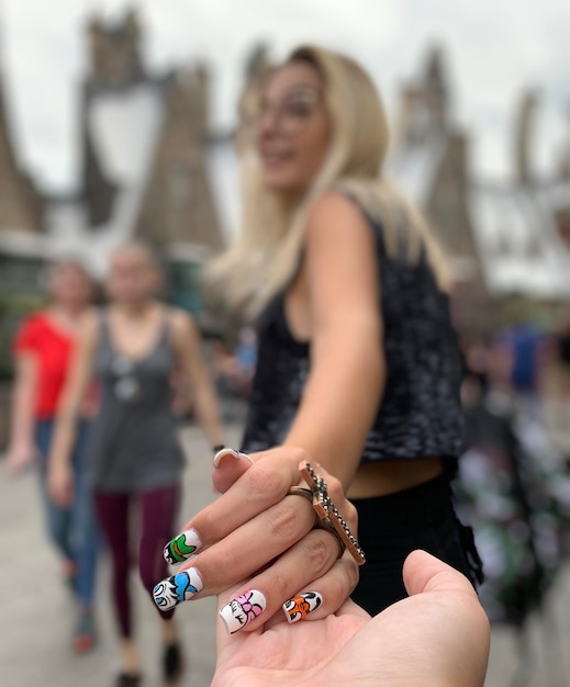 close-up of woman holding person hand