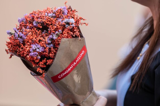 Photo close-up of woman holding red flower