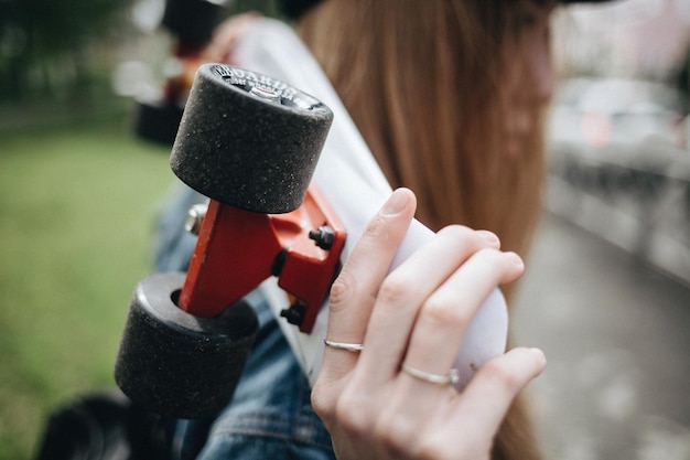 Photo close-up of woman holding skateboard