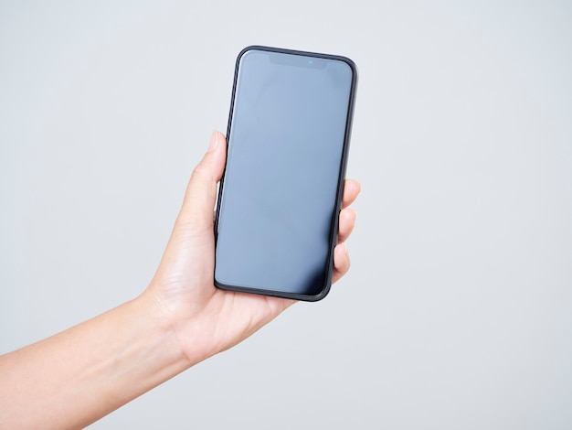 Close-up of woman holding smartphone with a blank screen