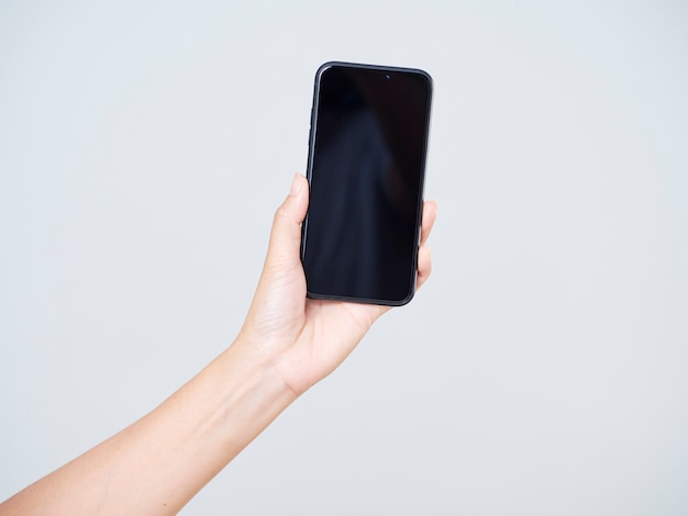 Close-up of woman holding smartphone with a blank screen