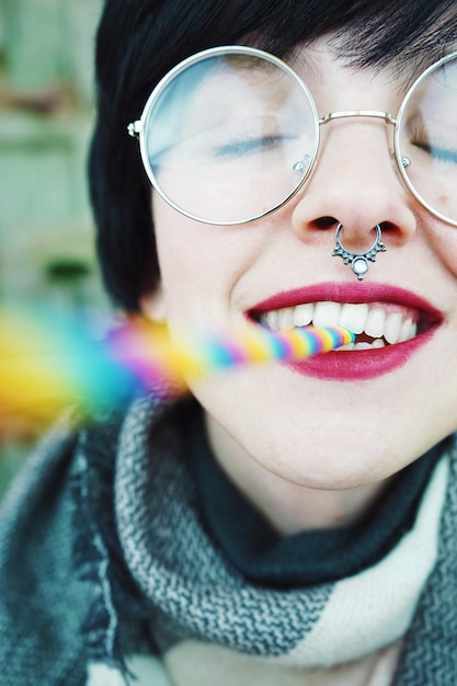 close-up of woman holding straw in mouth