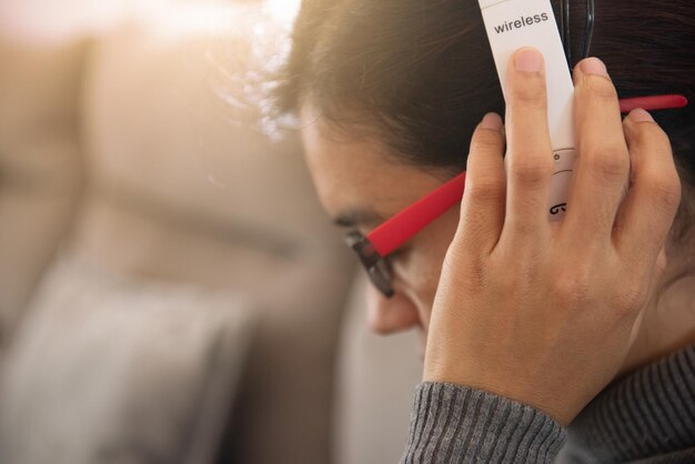 Close-up of woman listening music through headphones