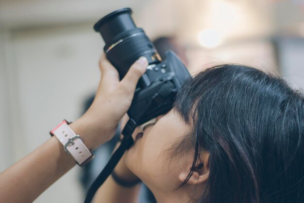 Close-up of a woman looking camera to take a picture.