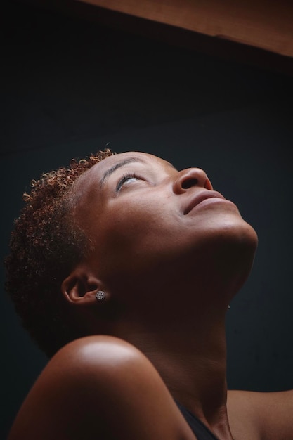 close-up of woman looking up in darkroom