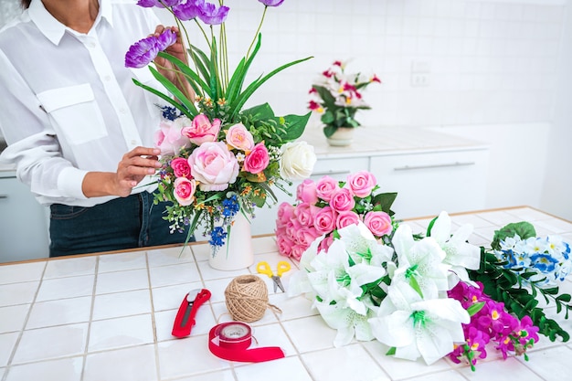 close up woman making floral arrangements