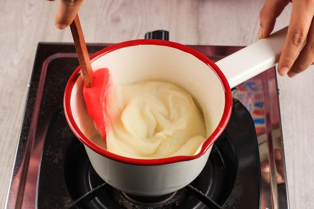 Close Up Woman Making Mashed Potato in Sauce Pan Mix with Milk for Creamy Mash Potato