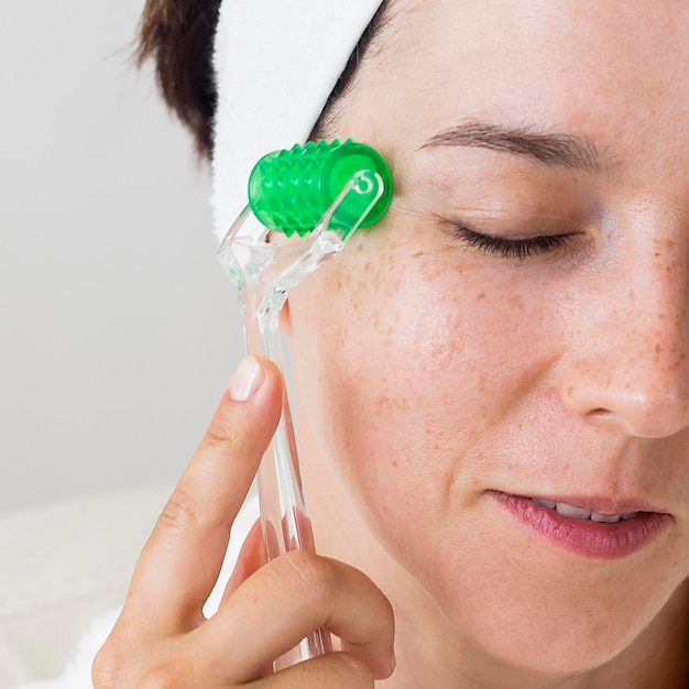 Close-up woman massaging her facial skin