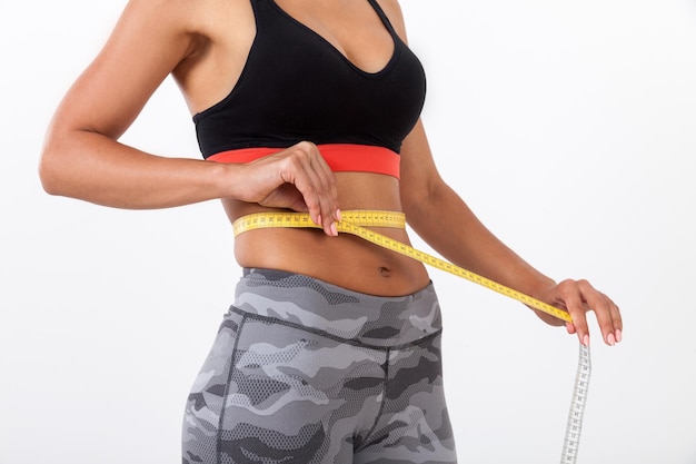 Close up of woman measuring waist