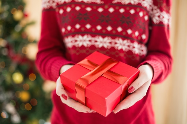 Close up of a woman offering a gift