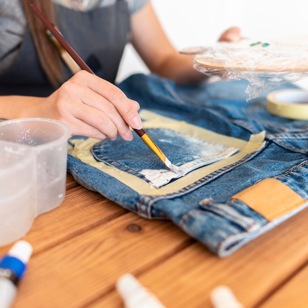 Photo close-up woman painting jeans